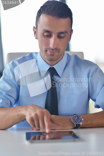 Image of business man using tablet compuer at office