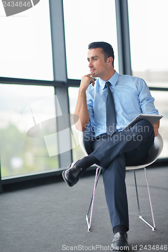 Image of happy young business man at office