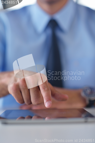 Image of business man using tablet compuer at office