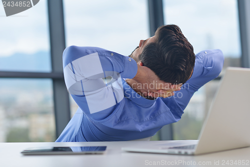 Image of happy young business man at office