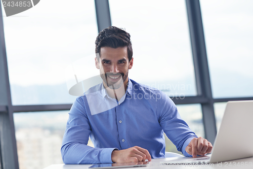 Image of happy young business man at office