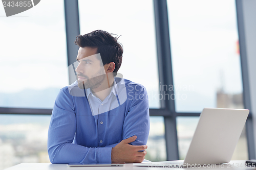 Image of happy young business man at office