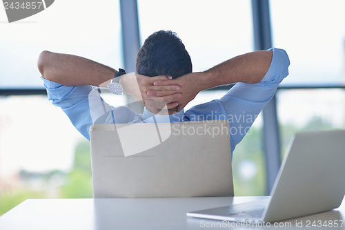 Image of happy young business man at office