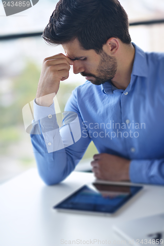 Image of happy young business man at office