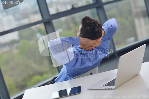 Image of happy young business man at office