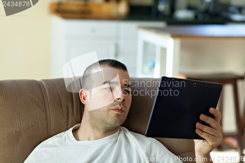 Image of Man Reading a Tablet Computer