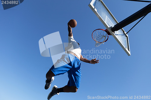 Image of Man Dunking a Basketball