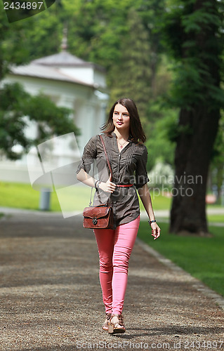 Image of Young Woman Walking in a Park