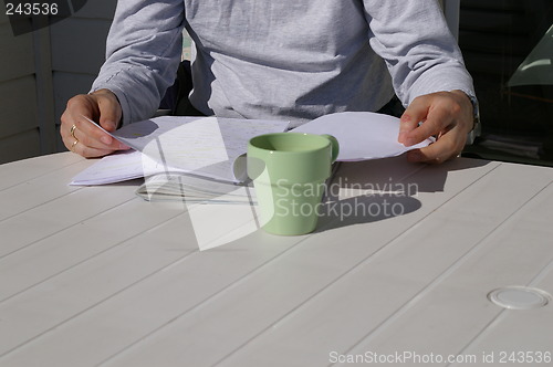 Image of Table with cup and papers