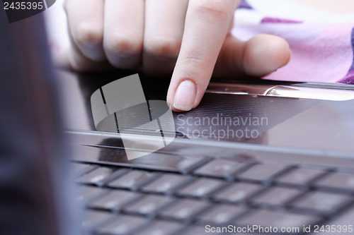 Image of Working at laptop .