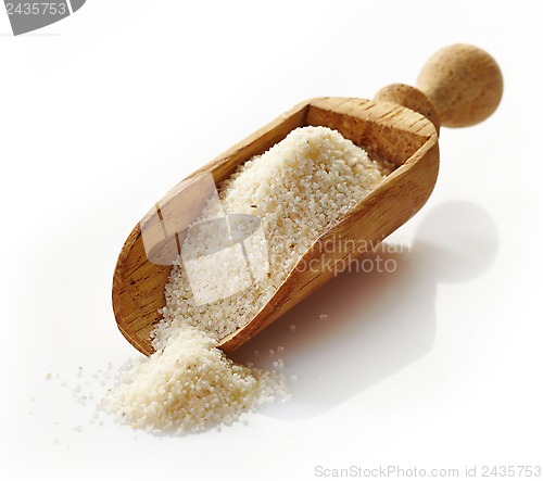 Image of wooden scoop with semolina croup