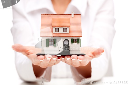 Image of Small toy house in hands