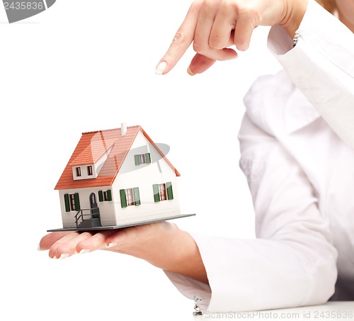 Image of hand holding house isolated on white background
