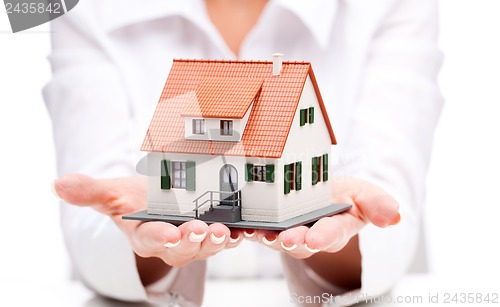 Image of Small toy house in hands