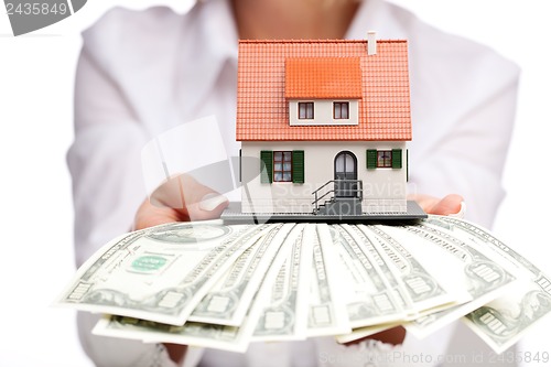 Image of Hands with money and miniature house on a white background