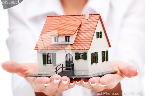 Image of Small toy house in hands