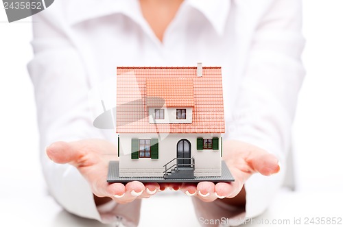 Image of Small toy house in hands