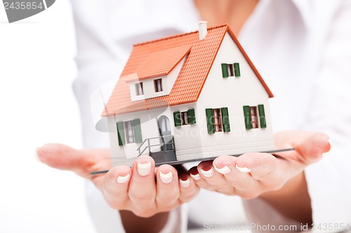 Image of Small toy house in hands