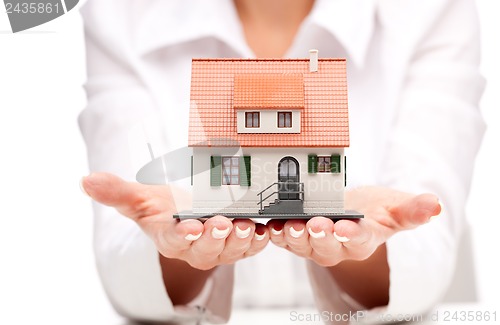 Image of Small toy house in hands