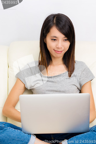 Image of Asian woman using laptop
