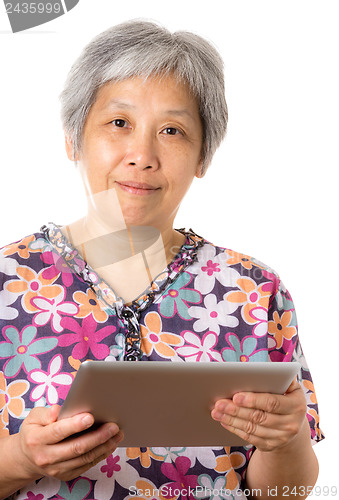 Image of Asian old woman using digital tablet