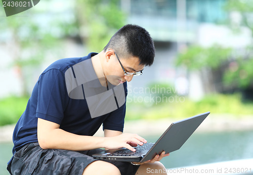 Image of man using computer outdoor