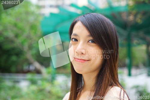 Image of young woman smiling friendly