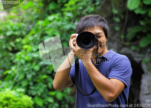 Image of Asian man taking photo