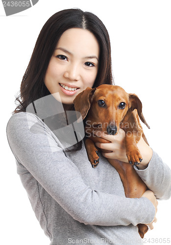 Image of asian woman with dachshund dog 