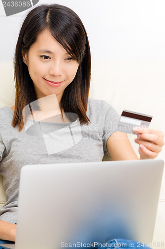 Image of Asian woman using laptop for online shopping