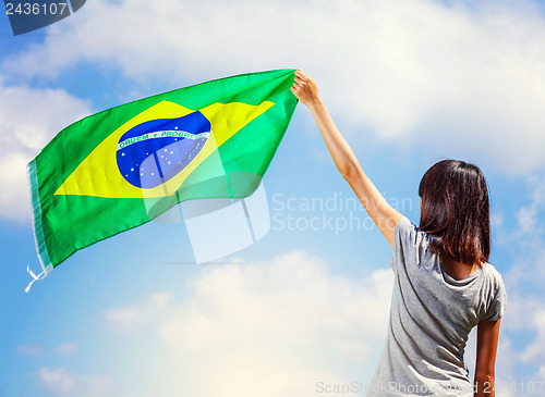 Image of Woman holding a brazil flag