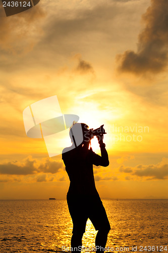 Image of Silhouette photographer at sunset