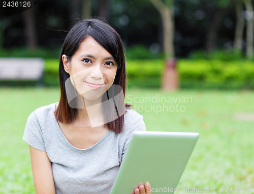 Image of Asian woman holding tablet