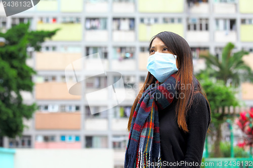 Image of Woman wearing medical face mask in crowded city