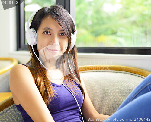 Image of Asian woman listen to music
