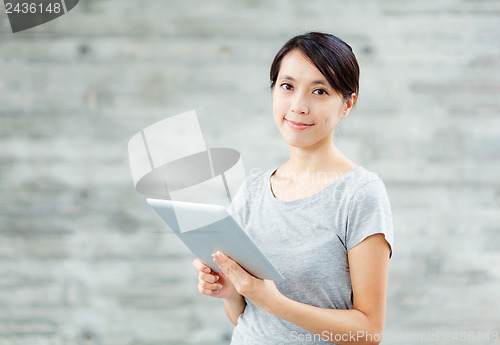 Image of Asian woman with digital tablet
