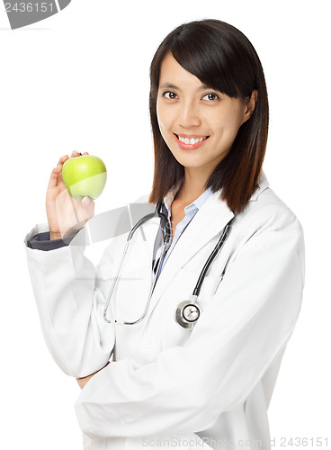Image of Asian female doctor holding green apple