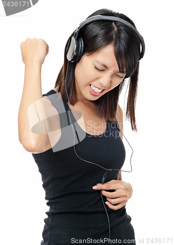 Image of Asian woman listen to rock music