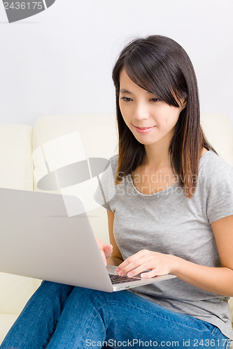 Image of Asian woman using laptop