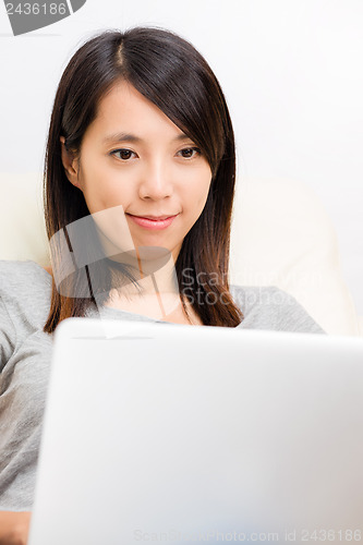 Image of Asian woman lookting at laptop