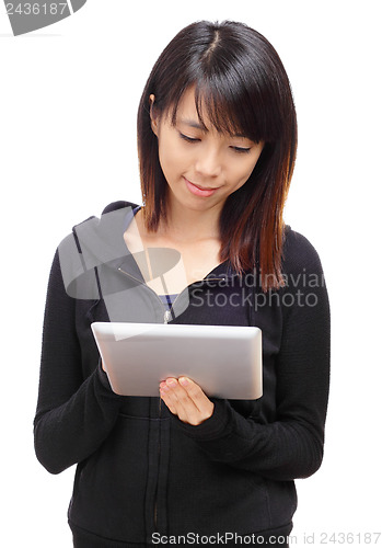 Image of Young asian woman using tablet computer