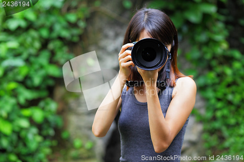 Image of Asian woman taking photo