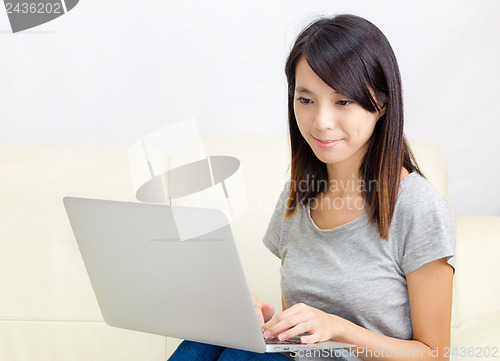 Image of Asian woman using laptop