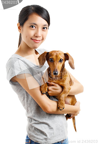 Image of Asian woman with dachshund dog