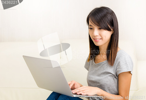 Image of Asian woman using laptop