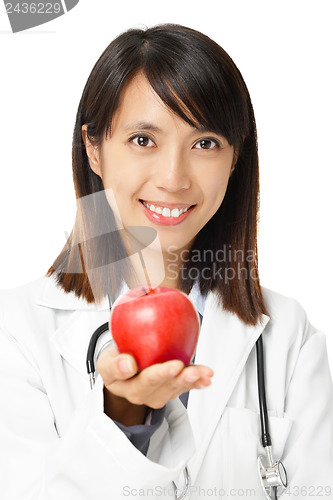 Image of Asian female doctor holding red apple