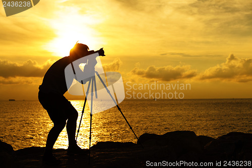 Image of Silhouette photographer at sunset