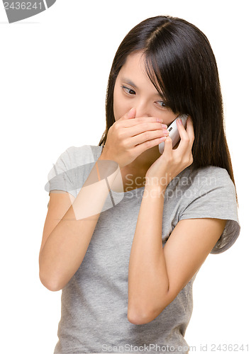 Image of Asian woman talking phone secretly 