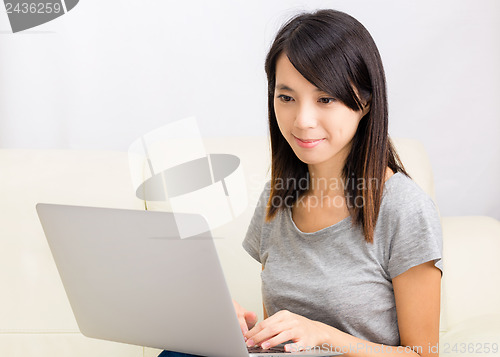 Image of Asian woman using laptop