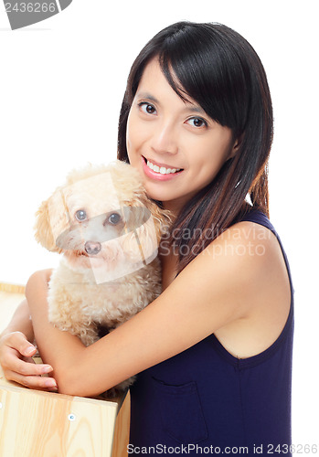 Image of Asian woman with dog poodle